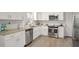 Modern kitchen with white cabinets and stainless steel appliances at 3611 Hillsborough Ln, Decatur, GA 30032