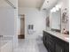 Well-lit bathroom showcasing a tiled shower and bathtub, double vanity, and white tiled floors at 1100 Howell Mill Rd # 404, Atlanta, GA 30318