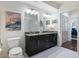 Bright bathroom featuring a double vanity with modern fixtures, framed mirror, and contemporary decor at 1100 Howell Mill Rd # 404, Atlanta, GA 30318