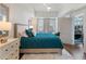 Bright bedroom with a plush bed, hardwood floors, and access to a balcony at 1100 Howell Mill Rd # 404, Atlanta, GA 30318