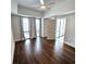 Bright bedroom featuring dark wood floors, a ceiling fan, and natural light from large windows at 1100 Howell Mill Rd # 404, Atlanta, GA 30318