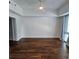 Spacious bedroom showcasing hardwood flooring, white walls, and a ceiling fan at 1100 Howell Mill Rd # 404, Atlanta, GA 30318