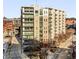 Modern multi-story condo building exterior with balconies, surrounded by mature trees and streetscapes at 1100 Howell Mill Rd # 404, Atlanta, GA 30318