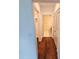 Hallway view showcasing hardwood floors, doors to bathroom and closet, and bright, neutral paint at 1100 Howell Mill Rd # 404, Atlanta, GA 30318