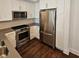 A modern kitchen with stainless steel appliances and white cabinets offers great functionality and design at 1100 Howell Mill Rd # 404, Atlanta, GA 30318