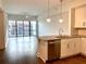 Bright open-concept kitchen featuring stainless steel appliances and an island with sink at 1100 Howell Mill Rd # 404, Atlanta, GA 30318