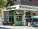 Bright restaurant exterior with green accents, large windows, and outdoor seating at 1100 Howell Mill Rd # 404, Atlanta, GA 30318