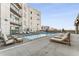 Rooftop pool area with comfortable lounge chairs offering stunning views of the city skyline at 1100 Howell Mill Rd # 404, Atlanta, GA 30318