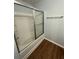 Clean bathroom with tub, shower, and wood-look flooring at 2805 Vining Ridge Ter, Decatur, GA 30034