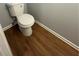Small bathroom with toilet and laminate wood flooring at 2805 Vining Ridge Ter, Decatur, GA 30034