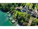 An aerial view showcases the expansive waterfront property with a pool and private dock at 6308 Woodlake Dr, Buford, GA 30518