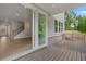 View of back porch featuring wood flooring and large sliding glass doors at 7530 Homer Dr, Cumming, GA 30028