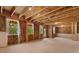 Unfinished basement space with exposed framing, windows, and room for future customization or expansion at 7530 Homer Dr, Cumming, GA 30028