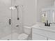 Modern bathroom features a tiled shower with glass door, white vanity, and sleek fixtures at 7530 Homer Dr, Cumming, GA 30028