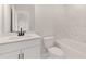 Bathroom featuring white tile accents, modern vanity, and white appliances at 7530 Homer Dr, Cumming, GA 30028