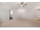 Spacious bedroom featuring a ceiling fan and neutral carpeting, and access to the bathroom at 7530 Homer Dr, Cumming, GA 30028