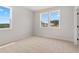 Bright bedroom features plush carpet, natural light, and neutral walls at 7530 Homer Dr, Cumming, GA 30028