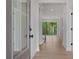 Welcoming entryway with hardwood floors, a clear view of the staircase, and ample natural light from the sidelight window at 7530 Homer Dr, Cumming, GA 30028