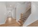 Hallway with wood floors and wood staircase at 7530 Homer Dr, Cumming, GA 30028