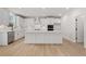 Modern kitchen with white cabinets, a large island, stainless steel appliances, and hardwood flooring at 7530 Homer Dr, Cumming, GA 30028