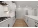 Modern kitchen features white cabinets, quartz countertops, stainless steel appliances, and recessed lighting at 7530 Homer Dr, Cumming, GA 30028
