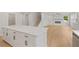 Bright kitchen island with white cabinets, quartz countertops, and modern hardware at 7530 Homer Dr, Cumming, GA 30028