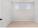 Bright walk-in closet featuring ample storage space, carpet, and a natural light from small windows at 7530 Homer Dr, Cumming, GA 30028