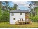 The backyard featuring a multi-level wooden deck, a lush lawn, and natural wooded scenery at 1709 Eastside Parc St, Atlanta, GA 30316