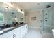 Bright bathroom features double vanities, granite countertop, large mirrors, modern fixtures, and a glass walk-in shower at 1709 Eastside Parc St, Atlanta, GA 30316