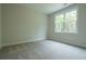 Bright, carpeted bedroom with a large window bringing in natural light at 1709 Eastside Parc St, Atlanta, GA 30316
