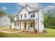 Charming two-story home with white siding, a metal roof, and a covered front porch at 1709 Eastside Parc St, Atlanta, GA 30316