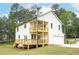 View of the home featuring multi-level wooden decks, an attached garage, and lush landscaping at 1709 Eastside Parc St, Atlanta, GA 30316