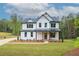 Beautiful two-story home with white siding, dark roof, covered porch, and a well-manicured lawn at 1709 Eastside Parc St, Atlanta, GA 30316