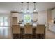 Bright kitchen with island seating, modern pendants, stainless appliances, and hardwood floors at 1709 Eastside Parc St, Atlanta, GA 30316