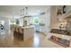 Bright kitchen with hardwood floors, white cabinets, and a center island with barstool seating at 1709 Eastside Parc St, Atlanta, GA 30316