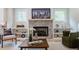 Cozy living area featuring a stone fireplace, built-in shelves, and natural light, creating a relaxing and inviting atmosphere at 1709 Eastside Parc St, Atlanta, GA 30316