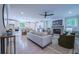 Spacious living room with a fireplace, modern ceiling fan, hardwood floors, and open concept design at 1709 Eastside Parc St, Atlanta, GA 30316