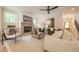 Bright living room featuring a stone fireplace, ceiling fan, and neutral decor, creating a comfortable and inviting space at 1709 Eastside Parc St, Atlanta, GA 30316