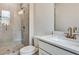 Well-lit bathroom with quartz countertop vanity, a glass-enclosed shower, and modern fixtures at 1697 Eastside Parc St, Atlanta, GA 30316
