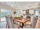 Bright dining room featuring a wooden table, modern chandelier, and access to the outdoor space at 1697 Eastside Parc St, Atlanta, GA 30316