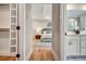 Hallway leading to the main bedroom and bathroom, showcasing hardwood floors and ample closet space at 1697 Eastside Parc St, Atlanta, GA 30316