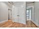Hallway featuring hardwood floors, neutral walls, and access to various rooms, creating a seamless flow at 1697 Eastside Parc St, Atlanta, GA 30316