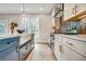 Elegant kitchen with white cabinets, stainless steel appliances, and designer finishes at 1697 Eastside Parc St, Atlanta, GA 30316