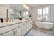 Luxurious main bathroom featuring a soaking tub, double vanity, and stylish fixtures, creating a spa-like experience at 1697 Eastside Parc St, Atlanta, GA 30316