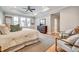 Spacious main bedroom with a tray ceiling, hardwood floors, and a large window at 1697 Eastside Parc St, Atlanta, GA 30316