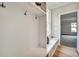 Mudroom with built-in storage, coat hooks, bench, and natural light, providing a functional and organized space at 1697 Eastside Parc St, Atlanta, GA 30316