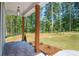 Covered front porch with brick flooring, wooden pillars, and a view of the landscaped yard at 1702 Eastside Parc St, Atlanta, GA 30316