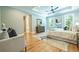 Sun-filled main bedroom with hardwood floors, sitting area, and a spacious layout create a serene and inviting atmosphere at 1702 Eastside Parc St, Atlanta, GA 30316