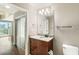 Bathroom with granite countertop, wood cabinet, large mirror and unique lighting at 361 17Th Nw St # 1001, Atlanta, GA 30363