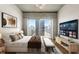 Bright and airy bedroom featuring a concrete ceiling and a balcony overlooking the city at 361 17Th Nw St # 1001, Atlanta, GA 30363